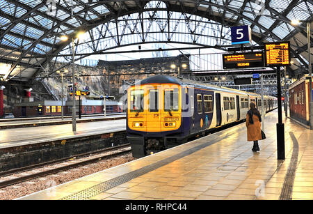 Train arriving at Liverpool Lime Street railway station at dusk in winter Stock Photo