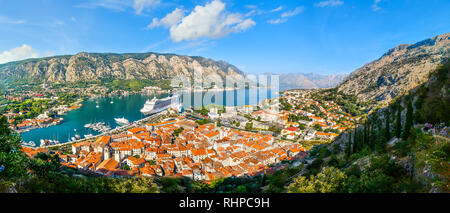 A panoramic view of the Bay of Kotor, cruise port, mountains and the medieval walled old town from the ruins of the Castle of San Giovanni Stock Photo
