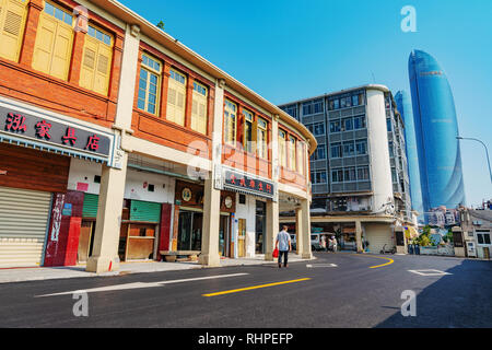 XIAMEN, CHINA -OCTOBER 09: This is a street with traditional buildings with the modern Shimao Straits Tower in the distance on October 09, 2018 in Xia Stock Photo