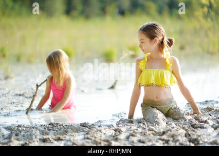 Young girl taking healing mud baths on lake Gela near Vilnius ...