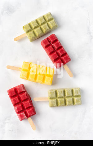 Fruit colorful sorbet lollipops on white background Stock Photo