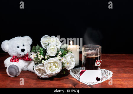 Beautiful bouquet of arranged flowers white candle on a holder, a hot glass of tea on a wooden table. mothers day, Easter, valentines, birthday, Chris Stock Photo