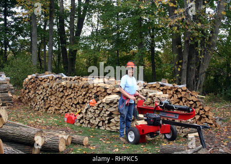 Cutting splitting and hauling firewood Stock Photo