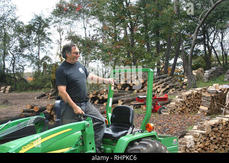 Cutting splitting and hauling firewood Stock Photo