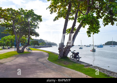 Street in Santa Barbara de Samana in front of the ocean with many boats, dominican repulic Stock Photo