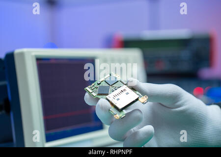 To repair the PCB of a modern monitor at the service center. Laboratory electronic processor technology Stock Photo
