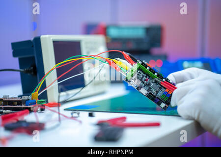 Development of electronic devices in the modern electronics laboratory, on a table, microprocessor oscilloscope and multimeter Stock Photo