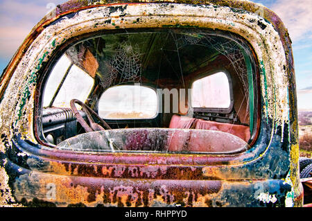 Rusty old truck sitting by the side of the road. Stock Photo