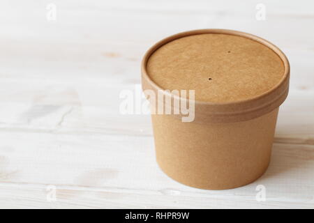 Kraft paper soup bowl with lid on a white table Stock Photo