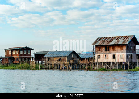 Traditional simple stilt houses and building of a village on Inle Lake, Myanmar. Stock Photo