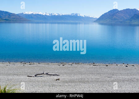 Lake Hawea expansive view from shore tp snow capped mountains in distance Stock Photo
