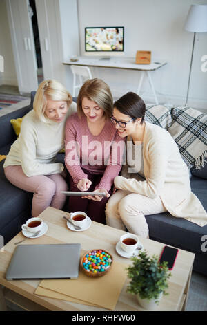 Three Women Using Digital Tablet Stock Photo