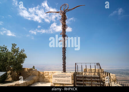 The serpentine cross sculpture, the Brazen Serpent created by Italian artist Giovanni Fantoni, on top of Mount Nebo in the sunlight against a blue sky Stock Photo