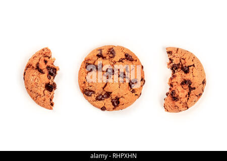 A freshly baked chocolate chip cookie and two halves of another, shot from the top on a white background with copyspace Stock Photo