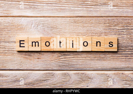 EMOTIONS word written on wood block. EMOTIONS text on wooden table for your desing, concept. Stock Photo
