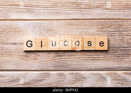 GLUCOSE word written on wood block. GLUCOSE text on wooden table for your desing, concept. Stock Photo