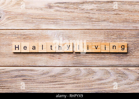 Healthy Living word written on wood block. Healthy Living text on wooden table for your desing, concept. Stock Photo