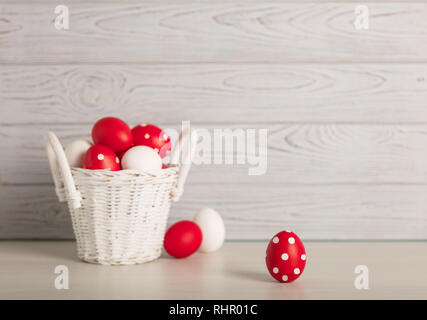 Happy Easter! Painted Easter eggs - red, white and red with white polka dots on a gray wooden background. Selective focus. Stock Photo