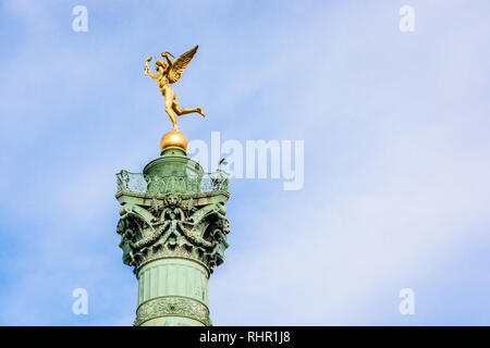 The Genius of Liberty golden statue atop the July Column in the center of Place de la Bastille in Paris, France, against blue sky. Stock Photo