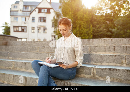 Woman wearing red camisole sitting near the house photo – Free