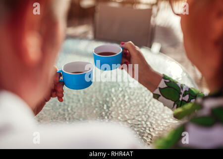 Senior couple drinking tea in hotel cafe. People enjoying vacation. Close-up Stock Photo