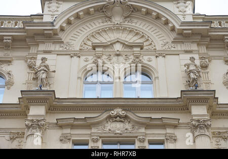 Close-up of lushly decorated upper part in the center of facade of old historic Neo Baroque building of 19th century on Porici (To the Beach) Street 7 Stock Photo