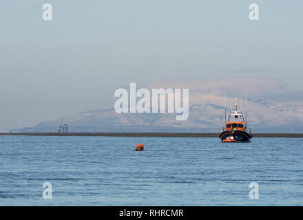 RNLI Lifeboat, at anchor in Wyre Estuary, Fleetwood, with Barrow-in-Furness in background Stock Photo