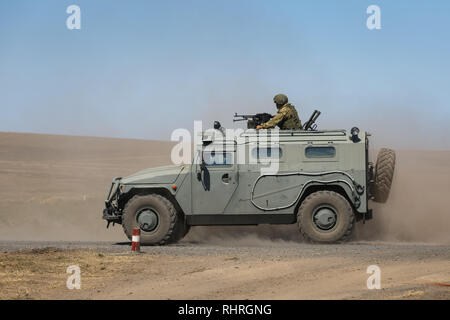 International military technical forum ARMY-2018. Armored car GAZ-233014 Tiger with a machine gunner upstairs quickly goes on a military training grou Stock Photo