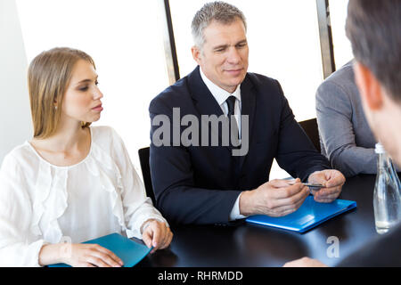 Business people discussing documents at workplace in office Stock Photo