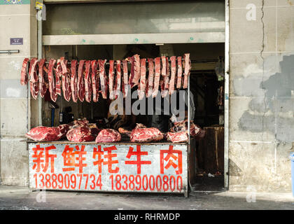 Big chunks of meat hanging from a butcher shop in Lhasa, Tibet Stock Photo