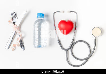 water and stethoscope with red heart isolated on white background, Diet and health care  concept Stock Photo
