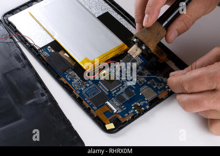 Repairman Soldering Electronic Device on White Background Stock Photo