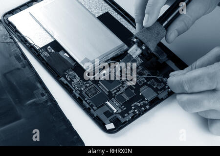 Repairman Soldering Electronic Device on White Background Stock Photo