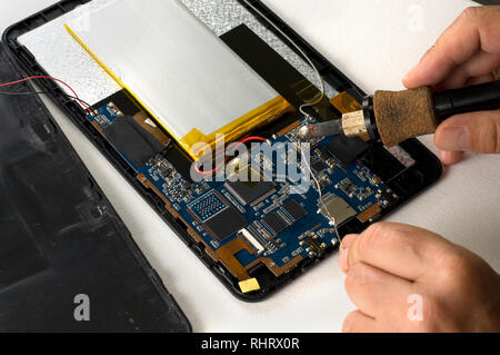 Repairman Soldering Electronic Device on White Background Stock Photo