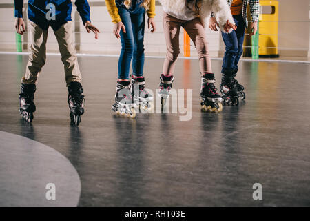 Cropped view of children preparing to start moving in roller skates Stock Photo