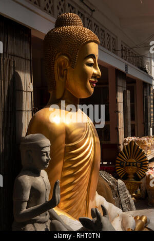 Cambodia, Phnom Penh, Preah Norodom Boulevard, Buddhist golden Buddha figure in alleyway Stock Photo