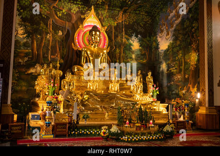 Cambodia, Phnom Penh, Wat Botum, inside Temple of Lotus Blossoms, gilded sitting and reclining Buddha figures at altar of main Prayer Hall Stock Photo