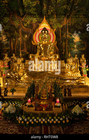 Cambodia, Phnom Penh, Wat Botum, inside Temple of Lotus Blossoms, gilded sitting and reclining Buddha figures at altar of main Prayer Hal Stock Photo
