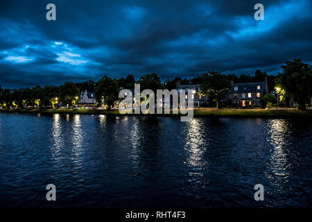 Illuminated Buildings In The Scenic Streets Of The City Of Inverness At The River Ness At Night in Scotland Stock Photo