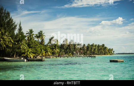 Palm-fringed white beaches at Pearl Beach Resort in Bora Bora Stock Photo