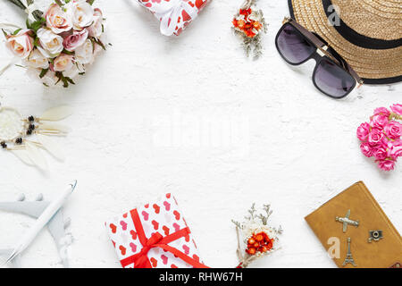 Flat lay table top view  of decorations valentine's day & summer travel hoilday background concept. Overhead shot items plan to travel. Rose flowers,  Stock Photo