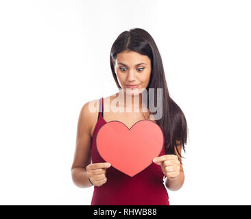 beautiful happy brunette woman holding and showing a big red heart Stock Photo