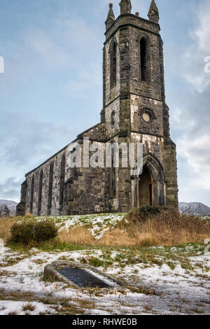 This is a picture  of the ruins of Dunlewy Church at the base of Errigal Mountain in Donegal Ireland. There is an over turned grave stone in the forgr Stock Photo