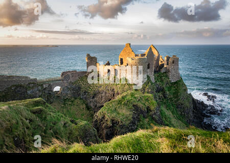 This is a picture of the ruins of Dunluce Castle in Northern Ireland.  It was built in the 13th century on the top of a sea cliff looking out to the A Stock Photo