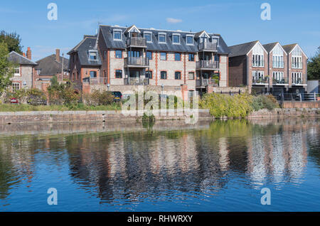 Wharf House luxury penthouse apartment block by the Chichester Canal, with reflections in the water in Chichester, West Sussex, England, UK. Stock Photo