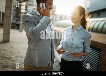 Picture of young attractive business partners standing Stock Photo