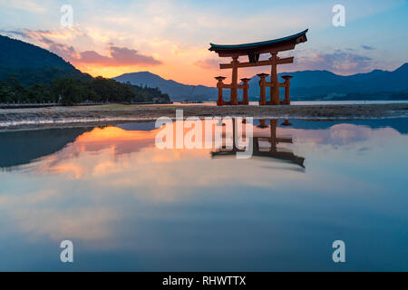 Torii of Itsukushima Shrine at sunset Stock Photo