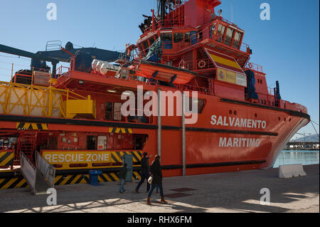 Malaga, MALAGA, Spain. 4th Feb, 2019. People are seen walking in front of the Spanish vessel ''Clara Campoamor'' docked at port of Malaga.The government of Pedro SÃ¡nchez said that the main vessel from the Spanish Maritime Rescue Service known as ''Clara Campoamor'' will control rescue operations of migrants at the Alboran Sea accompanied by members of the Spanish Civil Guard on board the vessel. The NGO 'Caminando Fronteras' (Walking borders) and the main union for rescue workers argue that the Spanish government attempt to dismantle and ''militarize'' a ''civil public service'', accord Stock Photo