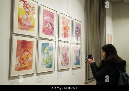 Brussels, Belgium. 4th Feb, 2019. A visitor takes photos of the Chinese zodiac exhibition in the China Cultural Center in Brussels, Belgium, Feb. 4, 2019. A set of activities such as performances, Chinese zodiac exhibition, calligraphy, etc., attracted some 200 visitors from across Europe to celebrate the Chinese Spring Festival in the center. Credit: Zheng Huansong/Xinhua/Alamy Live News Stock Photo