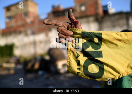 03 February 2019, Brazil, Rio de Janeiro: Nilton, 72, points his finger while holding a T-shirt with the words 'Rio' and 'Brasil' in his hand. Nilton has been involved in the carnival preparations for 28 years. Now he lives in the poor quarter of Barrerira do Vasco, where the figures of the carnival carts of the Alegrida da Zona Sul samba school were kept. The figures are to be recycled due to a lack of financial sources and partly reused in 2019. Alegrida da Zona Sul is the samba school of the Copacabana district. Carnival takes place in Rio 2019 at the beginning of March. Photo: Fabio Teixei Stock Photo
